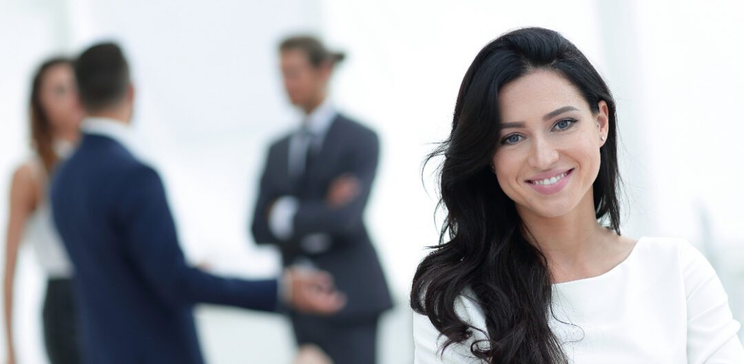 Businesswoman with colleagues behind her